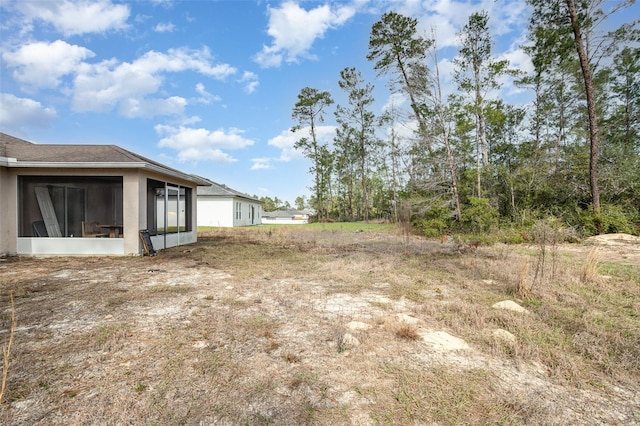 view of yard with a sunroom