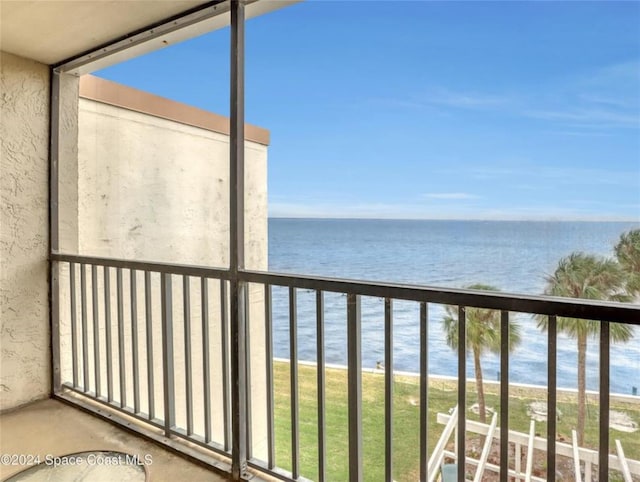 balcony with a beach view and a water view