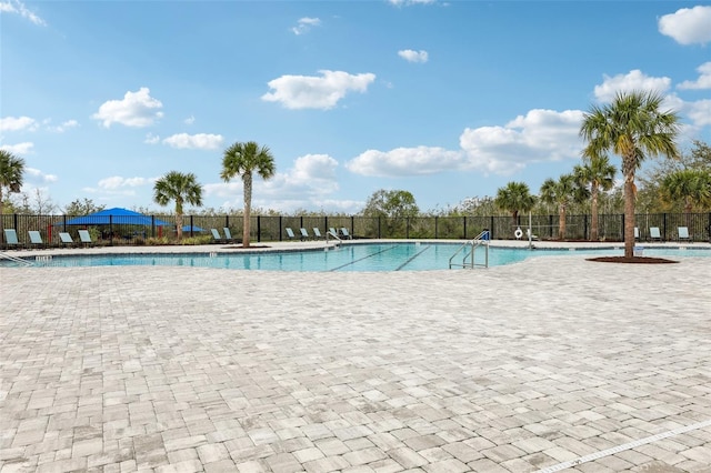 view of pool featuring fence