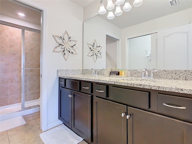 full bathroom featuring double vanity, visible vents, a stall shower, a sink, and tile patterned floors