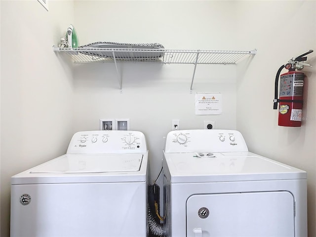 clothes washing area featuring laundry area and washing machine and dryer