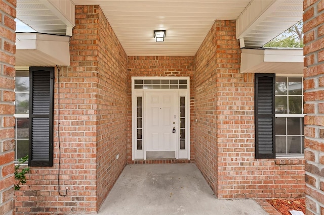 property entrance featuring brick siding