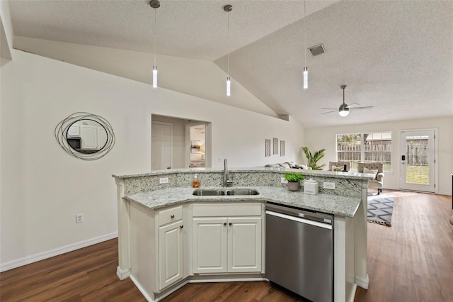 kitchen featuring visible vents, dishwasher, open floor plan, white cabinetry, and a sink