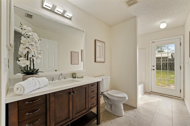 full bathroom with toilet, visible vents, a textured ceiling, and vanity