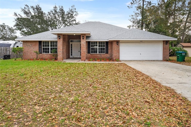 ranch-style home featuring a garage, driveway, a front lawn, and brick siding