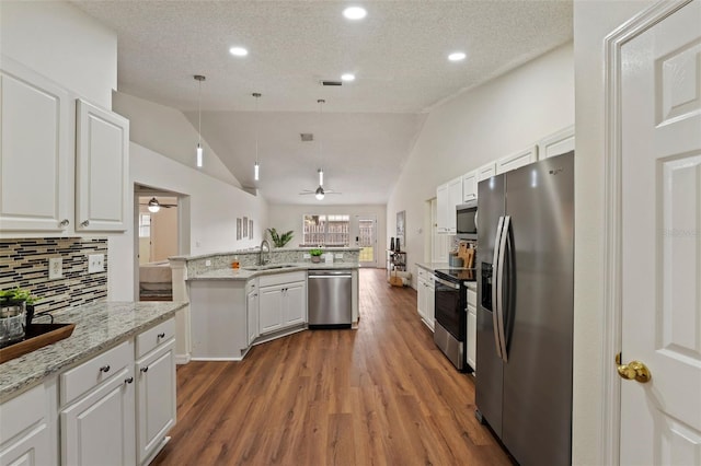 kitchen featuring appliances with stainless steel finishes, white cabinets, and a sink