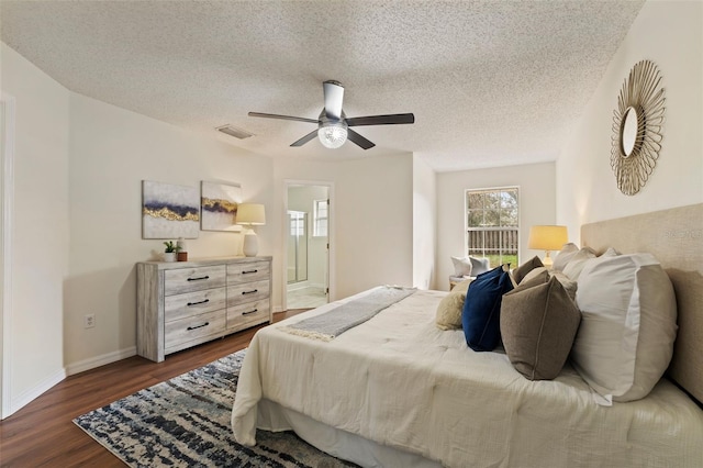 bedroom featuring visible vents, dark wood-type flooring, a ceiling fan, a textured ceiling, and baseboards