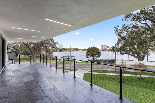 view of patio / terrace featuring a balcony and a water view