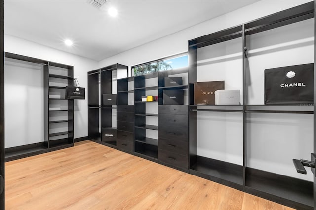 walk in closet featuring wood finished floors and visible vents