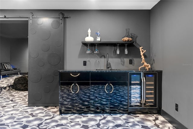 bar with wine cooler, a sink, wet bar, and a barn door