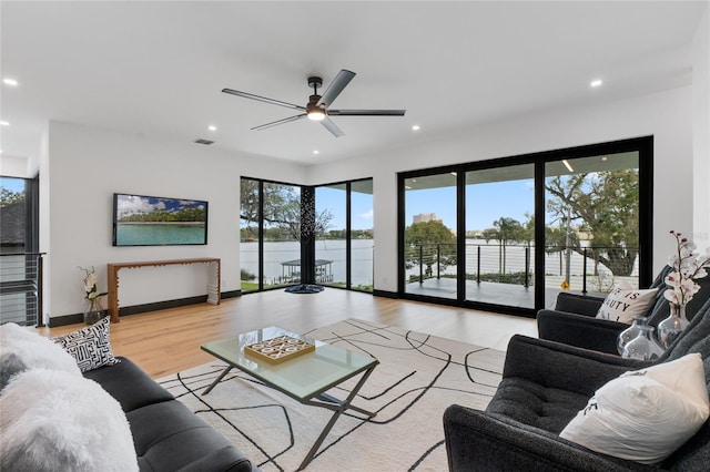 living area with plenty of natural light, visible vents, wood finished floors, and recessed lighting