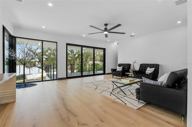 living area featuring recessed lighting, visible vents, and light wood-style flooring