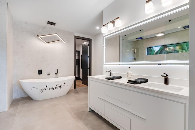 full bathroom featuring double vanity, tile patterned flooring, a tile shower, a freestanding tub, and a sink