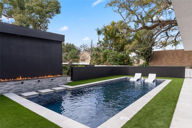 view of pool with a lawn, fence, and a fenced in pool