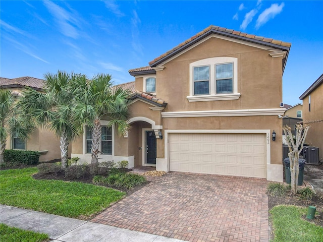 view of front of property featuring a tiled roof, decorative driveway, cooling unit, and stucco siding