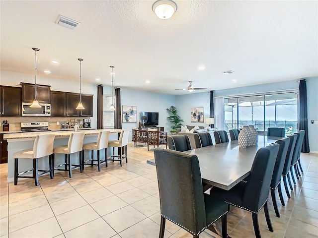 dining space with light tile patterned floors, visible vents, and recessed lighting