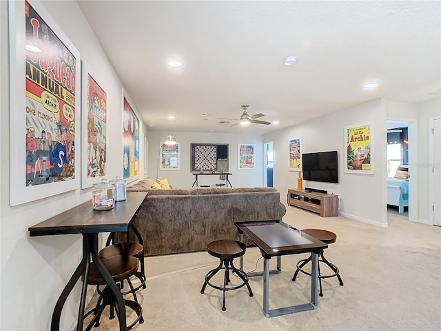 living area with baseboards, light carpet, a ceiling fan, and recessed lighting