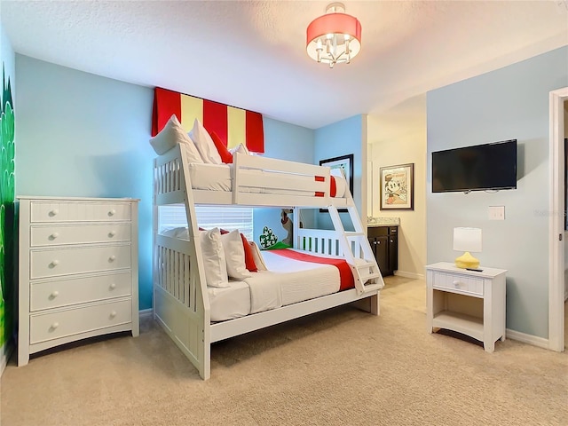 bedroom featuring light carpet and baseboards