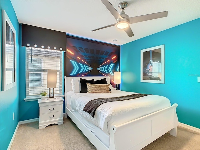 bedroom featuring a ceiling fan, carpet, and baseboards