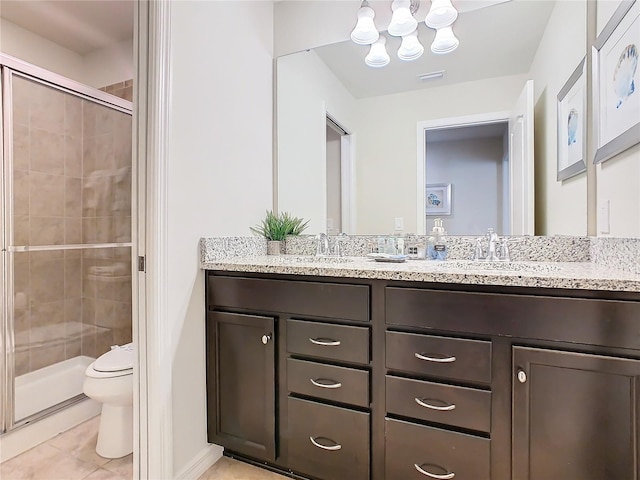 full bathroom featuring double vanity, a sink, toilet, and a shower stall