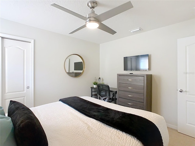 bedroom featuring light carpet, visible vents, and a ceiling fan