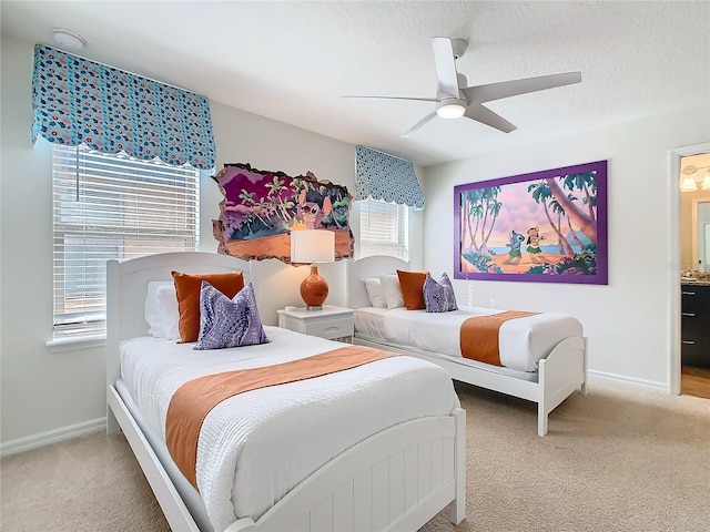 carpeted bedroom featuring a textured ceiling, ceiling fan, and baseboards