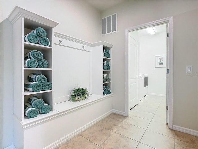 mudroom with visible vents, baseboards, and light tile patterned flooring