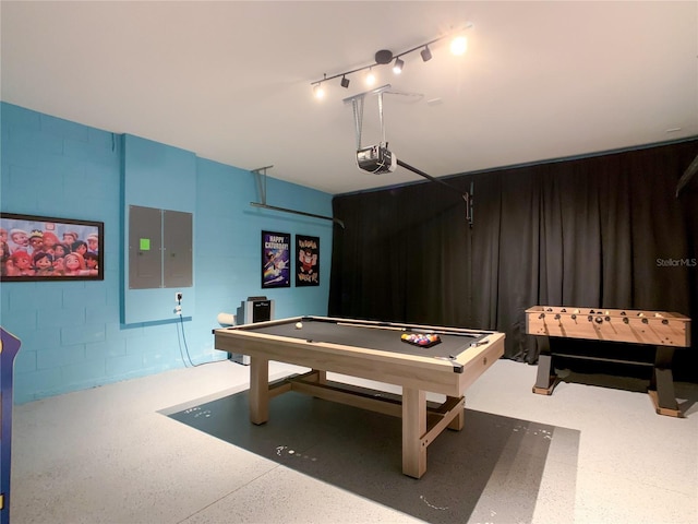 playroom with concrete block wall, billiards, a garage, and speckled floor