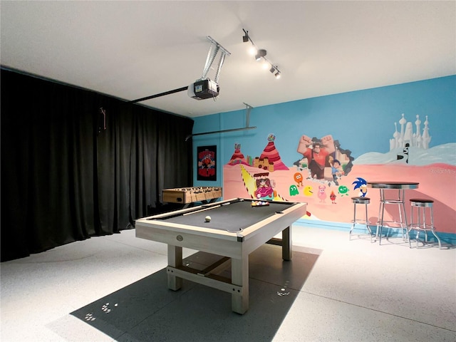 recreation room with a garage, pool table, and speckled floor