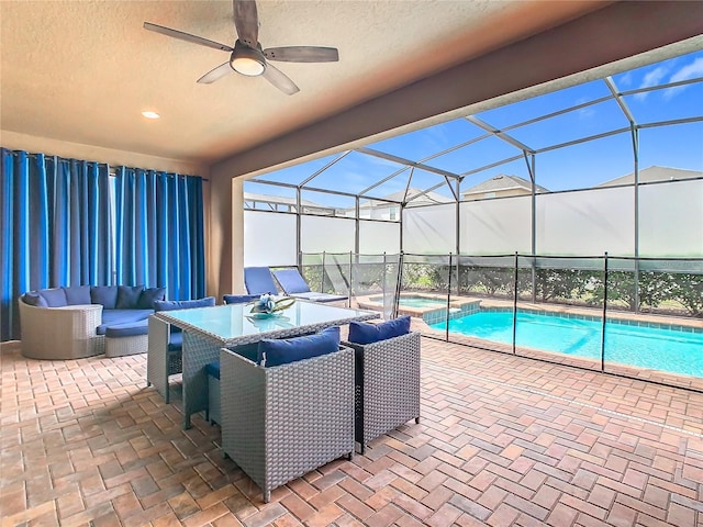 view of patio / terrace featuring a lanai, a pool with connected hot tub, and outdoor lounge area