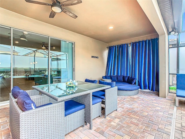 view of patio / terrace featuring outdoor dining area, ceiling fan, and an outdoor hangout area