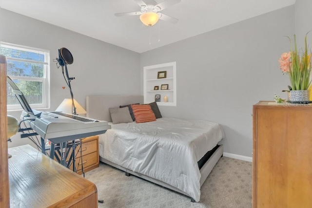 bedroom featuring light carpet, a ceiling fan, and baseboards