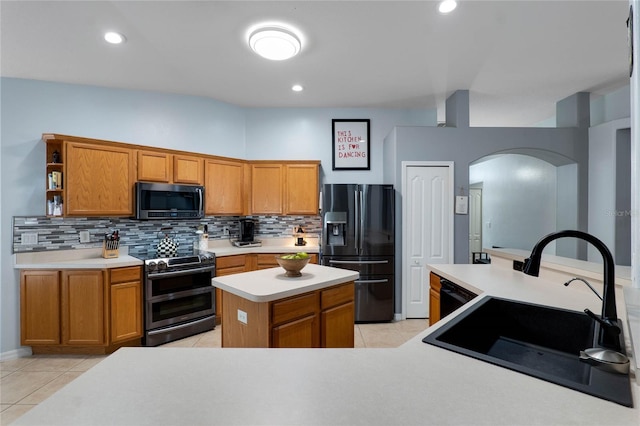 kitchen featuring open shelves, a sink, light countertops, a center island, and black appliances