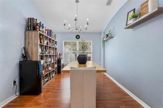 office with visible vents, baseboards, and wood finished floors