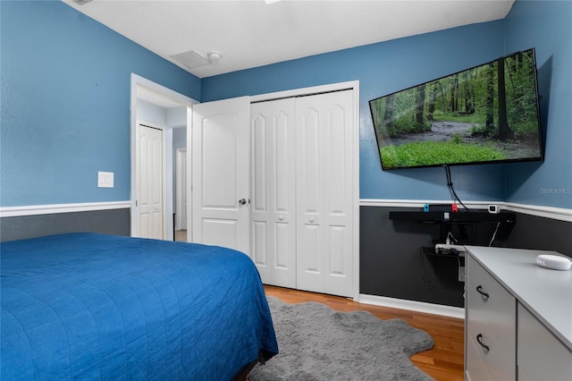 bedroom featuring baseboards and light wood finished floors