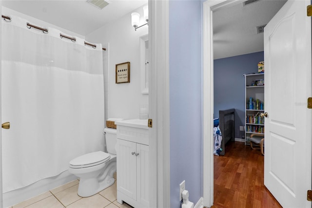 full bath with tile patterned flooring, visible vents, vanity, and toilet