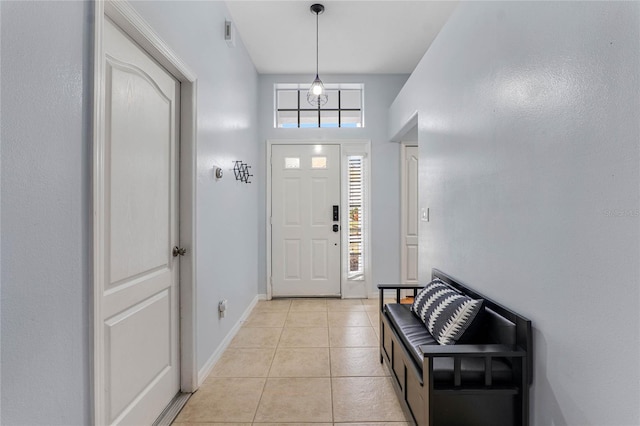 entrance foyer featuring light tile patterned flooring and baseboards