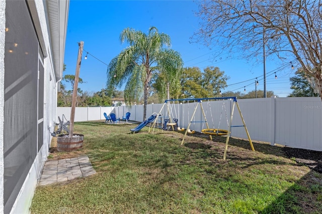 view of yard with a playground and a fenced backyard