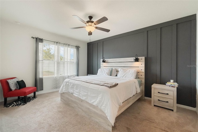 bedroom featuring baseboards, a ceiling fan, and light colored carpet