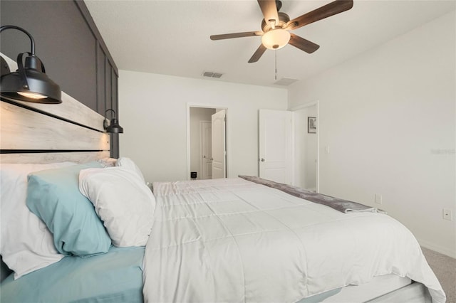 carpeted bedroom with visible vents and a ceiling fan