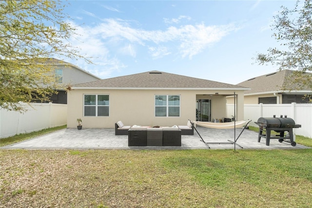 back of house with a patio, stucco siding, a lawn, a fenced backyard, and an outdoor living space