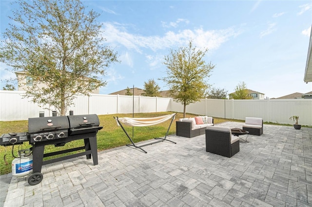 view of patio / terrace with outdoor lounge area, a fenced backyard, and a grill