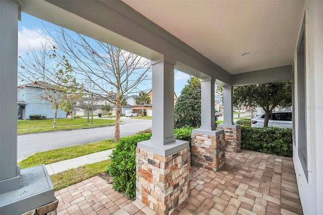 view of patio / terrace featuring a porch and a residential view