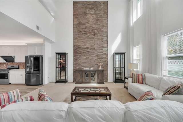 living area featuring light wood-type flooring and visible vents