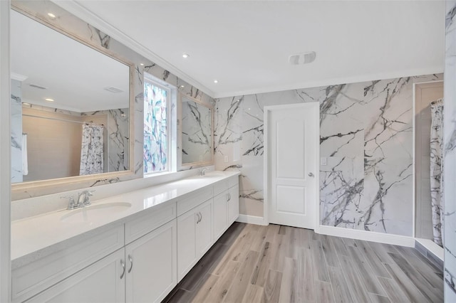 full bath featuring double vanity, a shower with curtain, a sink, and wood finished floors