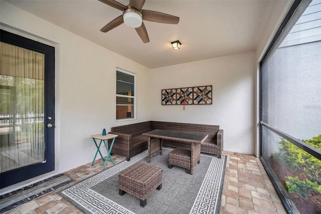 sunroom / solarium featuring ceiling fan