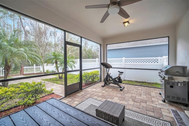 sunroom featuring a ceiling fan