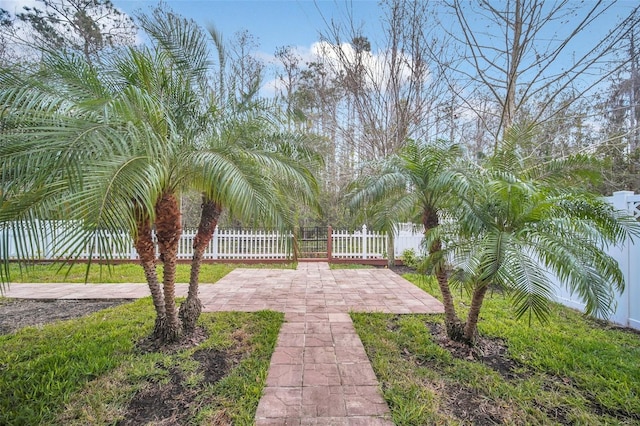 view of property's community with a patio and fence