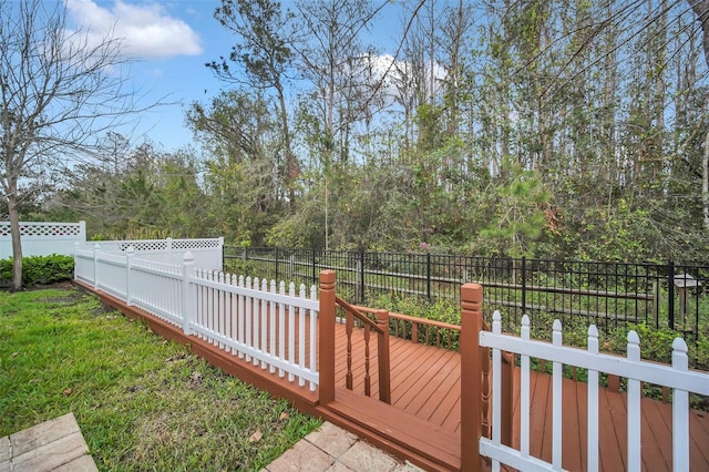 view of yard featuring fence and a deck