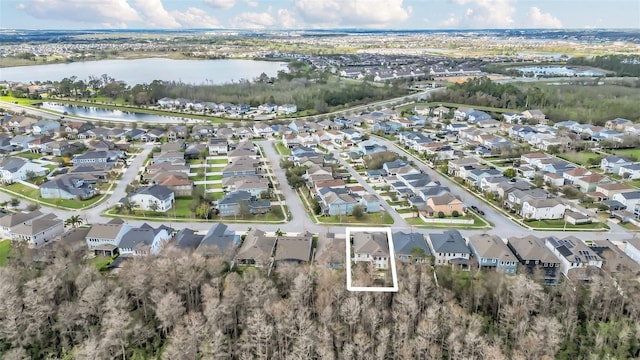 birds eye view of property with a residential view and a water view